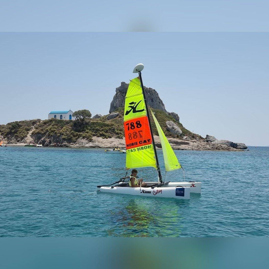 Catamaran sailing past Kastri Island
